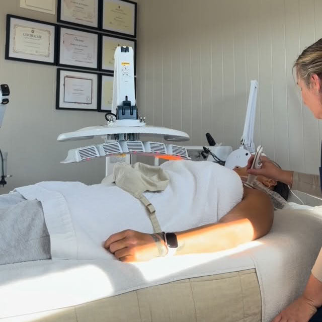 A client receiving skin treatment under LED light at Sol Studio, the Mount Maunganui clinic offering CAP Therapy